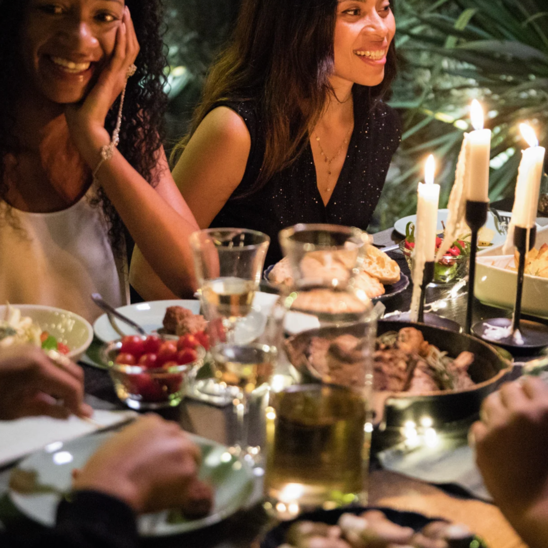 Two woman chatting at a Christmas party.